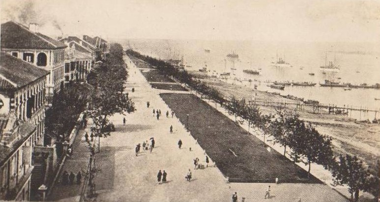 An old photograph of the Hankow Bund: a wide tree-lined promenade between Western-style buildings on the left and the Yangtze River on the right, with steamers and boats anchored offshore
